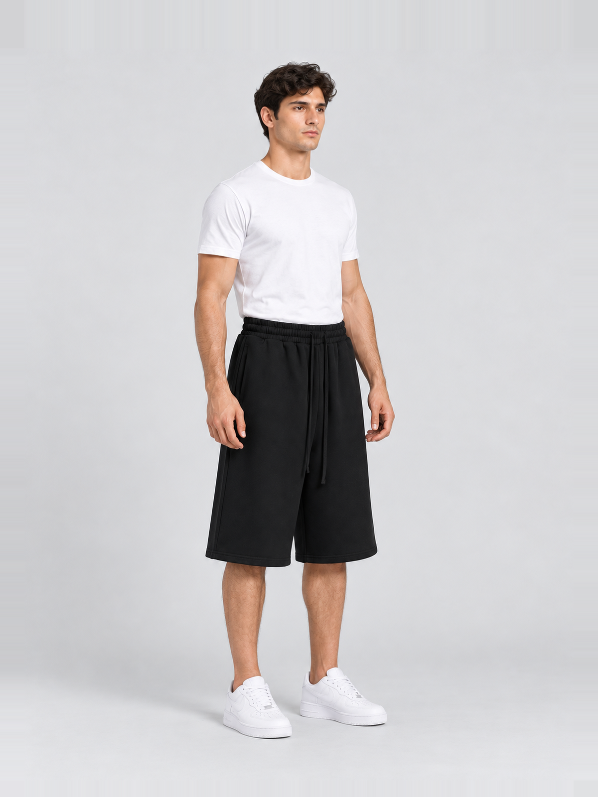 Men’s 400 GSM Cotton Wide-Leg Bermuda Sweat Shorts — model side Men's 400 GSM Cotton Wide-Leg Bermuda Sweat Shorts — model side