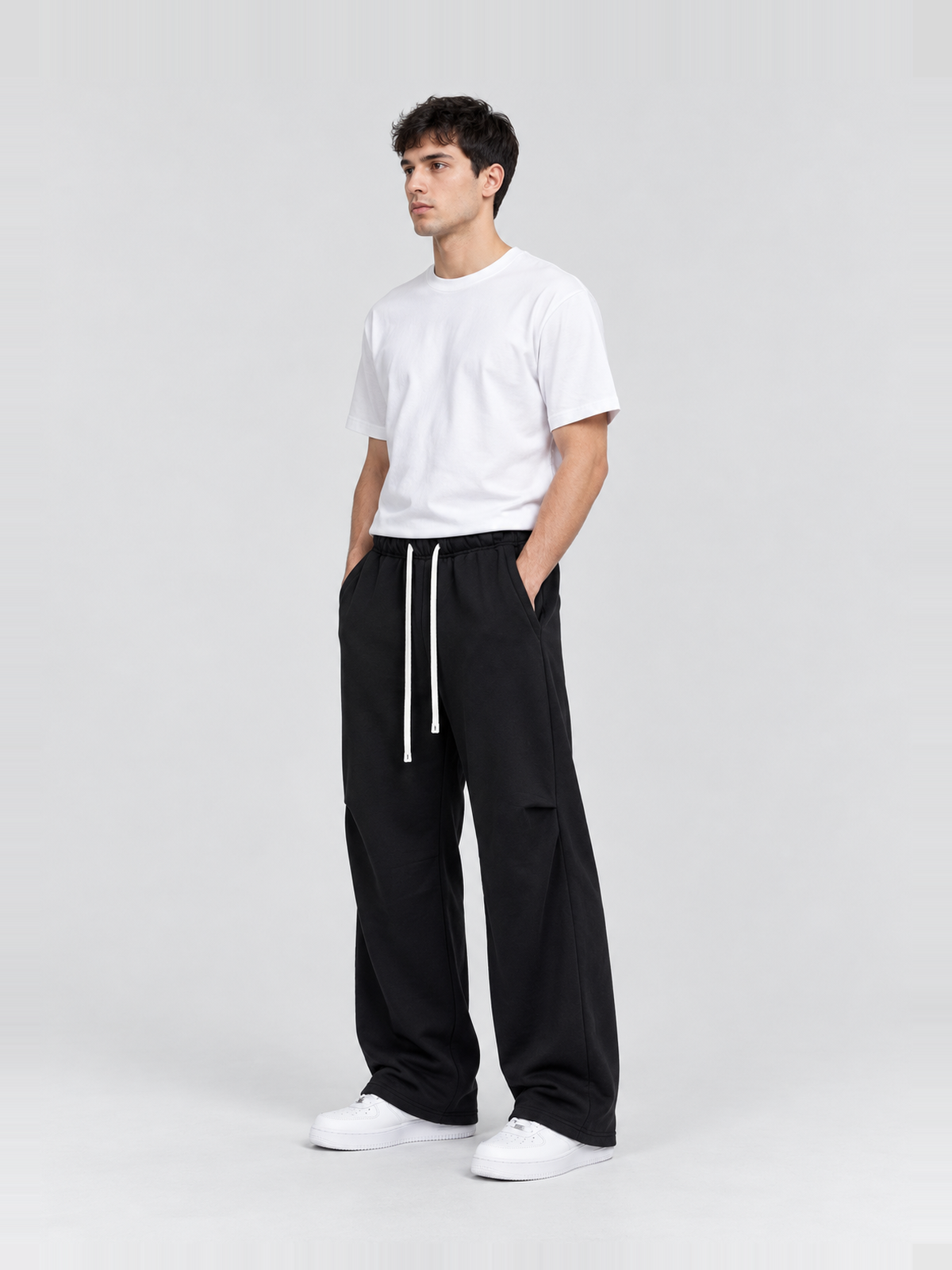 Men’s 400 GSM Curved-Seam Flared Sweatpants — model side Men's 400 GSM Curved-Seam Flared Sweatpants — model side