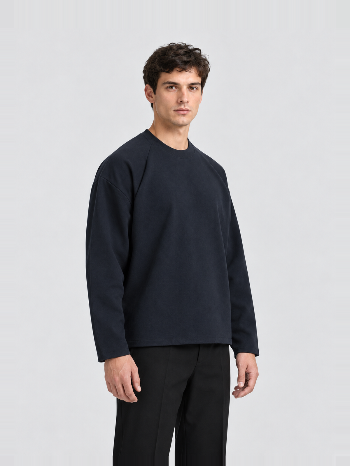 Men’s 280 GSM Cotton-Modal Curved-Sleeve Boxy Long-Sleeve T-Shirt — model side Men's 280 GSM Cotton-Modal Curved-Sleeve Boxy Long-Sleeve T-Shirt — model side